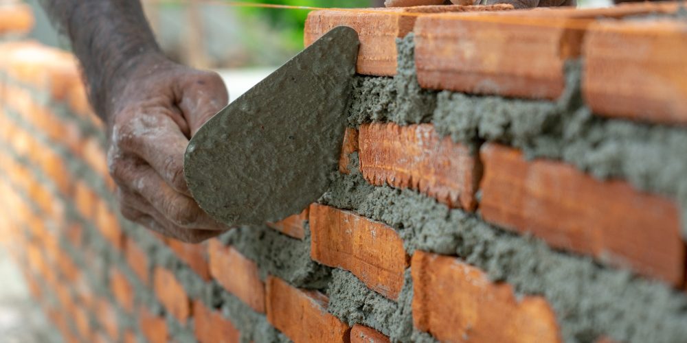 worker-uses-trowel-during-installing-the-bricklaye-YMCZ6T2